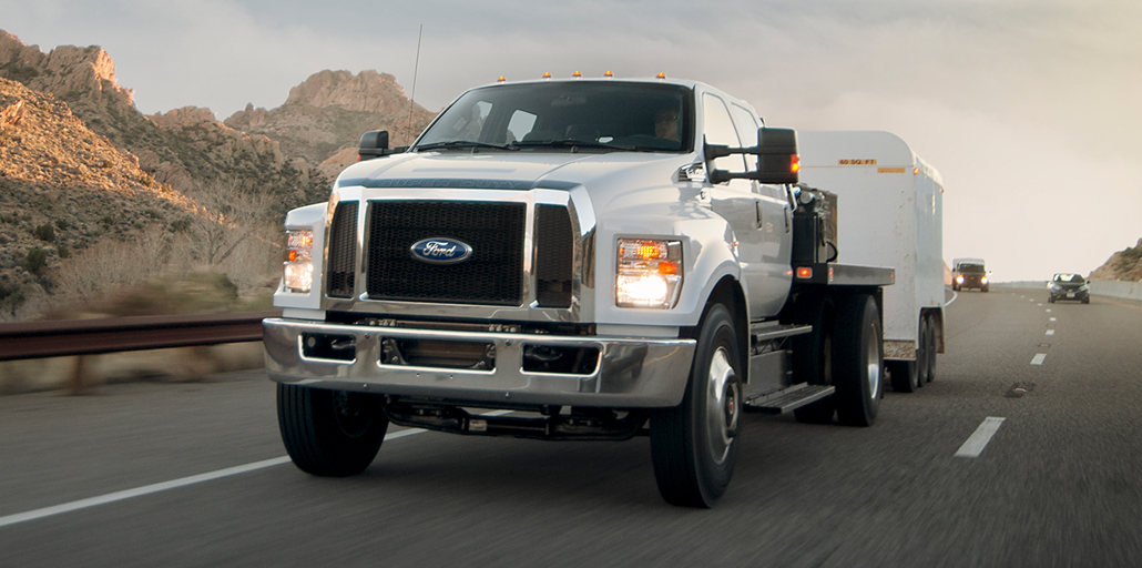 Ford Super Duty pickup with plow clearing snow.