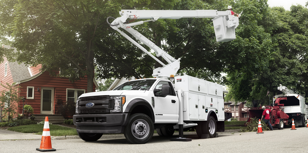 Ford Super Duty Chassis bucket list assisting a man in a tree